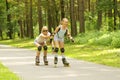 Mom and daughter ride on roller skates Royalty Free Stock Photo