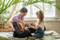 mom and daughter on the sofa, playing the guitar. a woman and a girl compose music, songs togethe Royalty Free Stock Photo