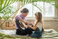 mom and daughter on the sofa, playing the guitar. a woman and a girl compose music, songs togethe Royalty Free Stock Photo