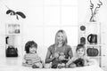 Mom daughter and son prepare a smoothie in the kitchen. Happy loving family. Have fun and play with vegetables. Healthy Royalty Free Stock Photo