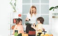 Mom daughter and son prepare a smoothie in the kitchen. Have fun and play with vegetables. Healthy diet and lifestyle Royalty Free Stock Photo