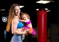 Mom and daughter in their hands posing in the gym. Royalty Free Stock Photo