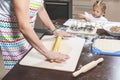 Mom and daughter together make dumplings in the kitchen