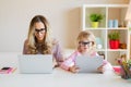 Mom and daughter using modern tech together