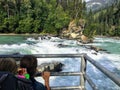 A mom and daughter viewing the salmon run in the summer