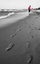 Mom and daughter walk - Footprint in coast Royalty Free Stock Photo