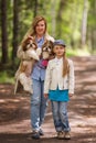 Mom and daughter walking in the park with the same two Shih Tzu dogs Royalty Free Stock Photo