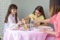 Mom with daughters fall asleep dye for coloring eggs in glasses with water