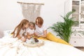 Family of five and their cat having breakfast in their bed in the morning Royalty Free Stock Photo