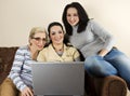Mom and daughters having fun with laptop