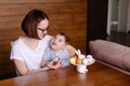 Mom and disabled son are painting Easter eggs in a lifestyle photo