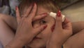 Mom drips eye drops to son. Mother drips son in eye medical solution