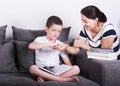 Mom encourages his son for reading a book. Royalty Free Stock Photo