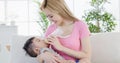 Mom feeding milk to son