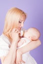 Mom feeds the baby from the bottle with teat Royalty Free Stock Photo