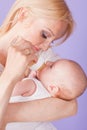Mom feeds the baby from the bottle with teat Royalty Free Stock Photo