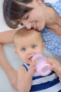 Mom feeds baby from bottle with teat