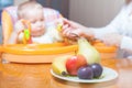 Mom feeds the baby pure. Juice. Drink Royalty Free Stock Photo