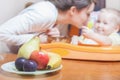 Mom feeds the baby pure. Juice. Drink Royalty Free Stock Photo