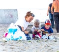 Mom feeds children on the beach Royalty Free Stock Photo