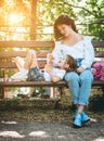 Mom feeds her little daughter ice cream in the park Royalty Free Stock Photo