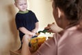 Mom feeds toy dinosaurs from a spoon Royalty Free Stock Photo