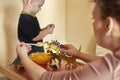 Mom feeds toy dinosaurs from a spoon Royalty Free Stock Photo