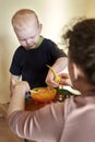 Mom feeds toy dinosaurs from a spoon Royalty Free Stock Photo