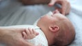 Mom gently caresses the hand of her newborn baby. Skin to the skin. Happy motherhood