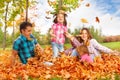 Mom and girls throw leaves up in the air Royalty Free Stock Photo