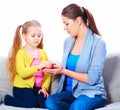 Mom gives a girl a red apple. Royalty Free Stock Photo