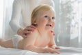 Mom gives her baby a shoulder and back massage. Close-up. Royalty Free Stock Photo