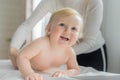 Mom gives her baby a shoulder and back massage. Close-up. Royalty Free Stock Photo