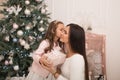 Mom gives her beloved daughter a box with a Christmas present