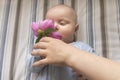 Mom gives her little baby a flower Royalty Free Stock Photo