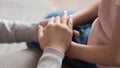 Mom giving support trust to little daughter holding hands, closeup