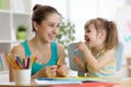 Mom helping her child to work colored paper