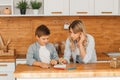 Mom helping little boy to do homework. Mother and son drawing together, mom helping with homework. Cute boy doing his school Royalty Free Stock Photo