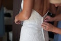 Mom helps dress bride wedding from a back Royalty Free Stock Photo