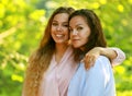 Mom and her adult daughter are hugging in the park, summer day Royalty Free Stock Photo