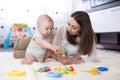 Mom and her child playing with colorful logical toy Royalty Free Stock Photo