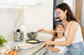 Mom and her daughter fry pancakes Royalty Free Stock Photo