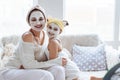 Mom with her daughter making clay face mask