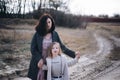 Mom and her daughter are playing and hugging outdoor