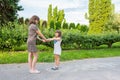 Mom with her daughter plays on the street on a sunny day. Family day off Royalty Free Stock Photo