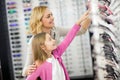 Mom and girl choose beautiful framework for eyeglasses Royalty Free Stock Photo