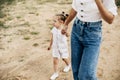 Mom and her little daughter are walking, holding hands, spending time together Royalty Free Stock Photo