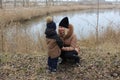 Mom and her little son are walking down the street in the countryside in winter. Royalty Free Stock Photo