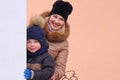 Mom and her little son are walking down the street in the countryside in winter. Royalty Free Stock Photo