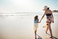 Mom with her nearest and dearest. Rear view shot of a mother and her little daughter bonding together at the beach. Royalty Free Stock Photo